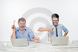 The two colleagues working together at office on white background