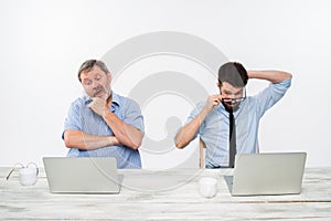 The two colleagues working together at office on white background