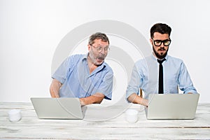 The two colleagues working together at office on white background