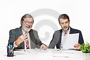 The two colleagues working together at office on white background.