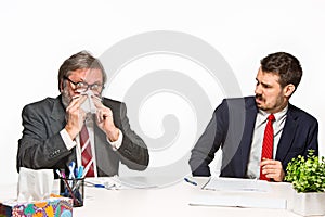 The two colleagues working together at office on white background.