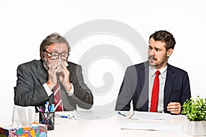 The two colleagues working together at office on white background.