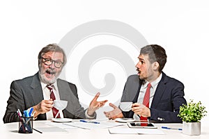 The two colleagues working together at office on white background.