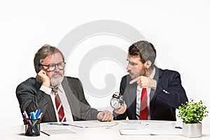 The two colleagues working together at office on white background.