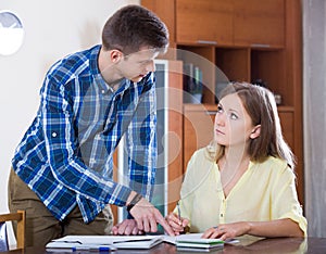 Two collegues working with documents together in office