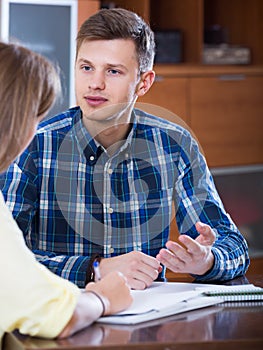 Two collegues working with documents together in office