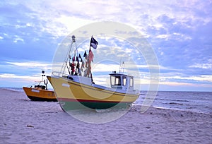 Two color boats an sea coast with blue sky