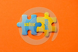 Two colored details of puzzle with text value price on orange background, Yellow and Blue, close up.