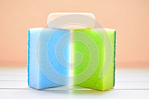 Two colored sponges and white soap for cleaning