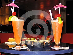 Two colorful coctails on the table of a cruise ship bar on vacation