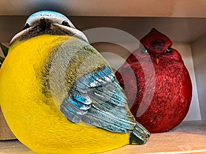 Two colorful fat bird statutes