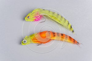 Two Colorful Fly Fishing Flies on Gray Background