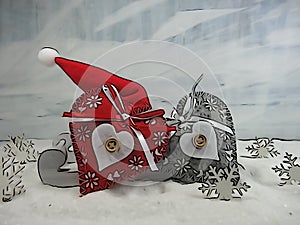 Two colorful hearts on a sleigh ans santa hat - The magic of Christmas