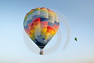 Two colorful hot air balloons on blue sky background