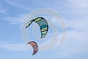 Two Colorful kitesurfing sails fly in the sky