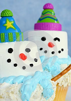 Two colorful snowmen cupcakes