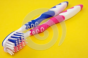 Two colorful tooth-brushes