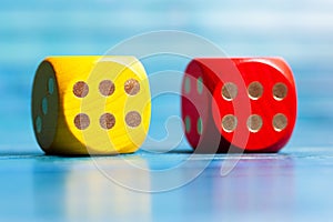Two colorful wooden game dice showing number six, luck in board games, good chances, great odds abstract concept. Lucky roll