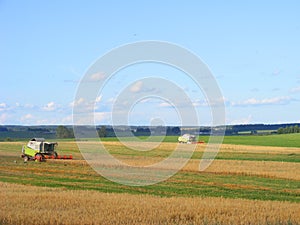 Two combines harvester00000 working in a very wide field