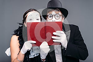 Two comedy performers posing with book