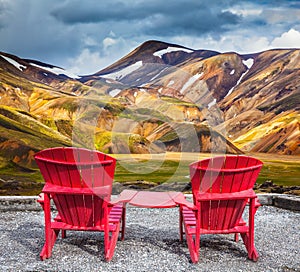 Two comfortable red deck chairs