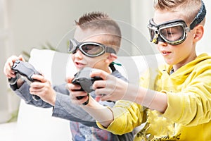 Two competitive young boys playing computer games