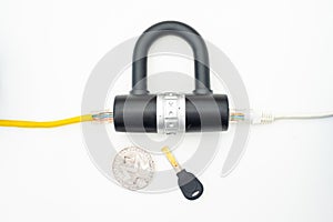 Two computer network cables going through a lock with a key and a crypto currency coin