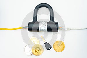 Two computer network cables going through a lock with a key and a crypto currency coin