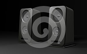 Two computer speakers over black background