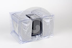 Two computer speakers in transparent plastic bag on white background