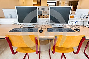 Two computers in classroom on high school