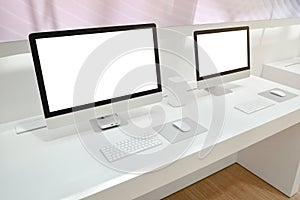Two computers with isolated screens for mockup on office desk