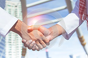 Two confident arab businessman shaking hands. Successful business partners. Negotiating business.