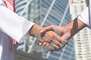 Two confident arab businessman shaking hands. Successful business partners. Negotiating business.