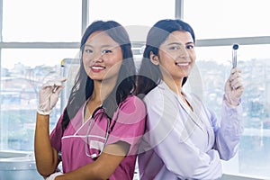 Two Confident Asian Nurse and Doctor standing side by side in a hospital