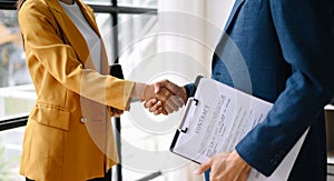 Two confident business man shaking hands during a meeting in the office, success, dealing, greeting and partner