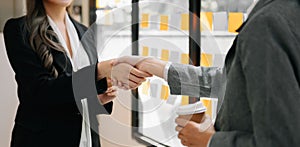 Two confident business man shaking hands during a meeting in the office, success, dealing, greeting and partner