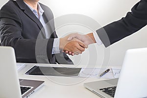 Two confident business man shaking hands during a meeting in the office, success, dealing, greeting and partner concept