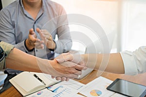 Two confident business man shaking hands during a meeting in the office, success, dealing, greeting and partner concept