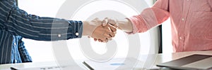 Two confident business man shaking hands during a meeting in the office, success, dealing, greeting and partner concept