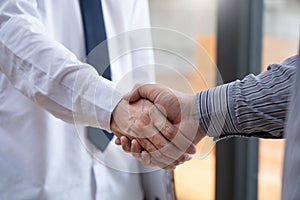 Two confident business man shaking hands during a meeting in the office, success, dealing, greeting and partner concept