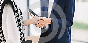 Two confident business man shaking hands during a meeting in the office, success, dealing, greeting and partner in sun light