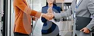 Two confident business man shaking hands during a meeting in the office, success, dealing, greeting and partner in sun light