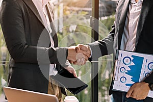 Two confident business man shaking hands during a meeting in the office, success, and partner