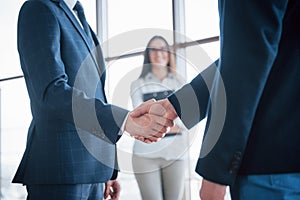 Two confident business man shaking hands during a meeting in the office, success, dealing, greeting and partner concept