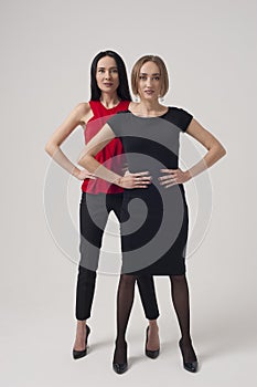 Two confident businesswomen standing with hands on the hips