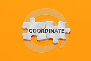 Two connected puzzle pieces with the word coordinate. Coordination and organization in business