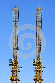 Two construction cranes