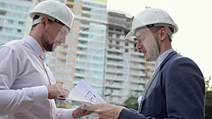 Two construction engineers discussing a construction plan