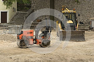 Two construction vehicles in building land